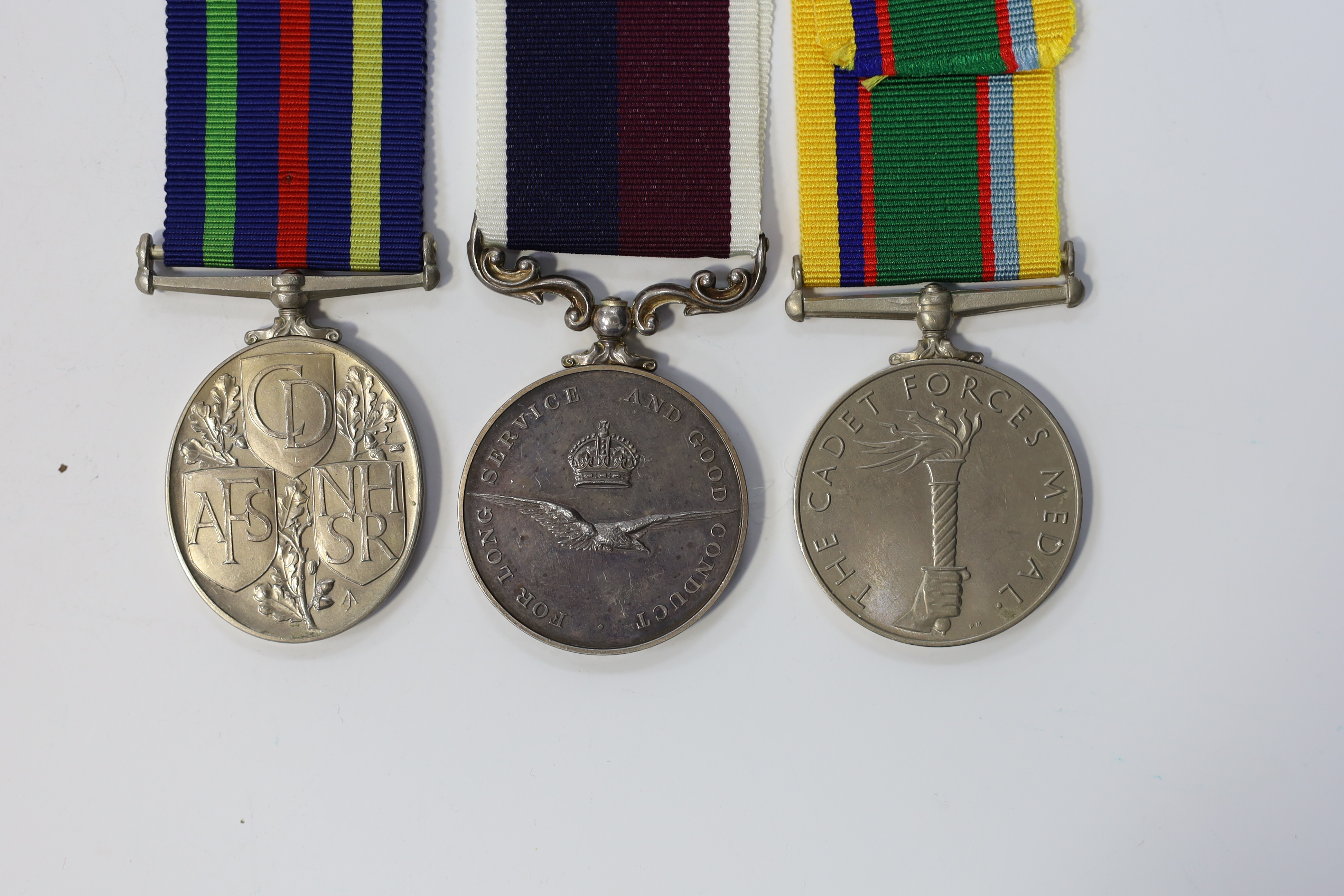 Three assorted service medals; GVI Cadet Forces medal to ACT. FG. Off. A. Liddell R.A.F.V.R (T); ERII Civil Defence Long Service medal unnamed; ERII RAFLSGC to E2418184 Cpl G R B Lowe RAF. Condition - fair to good.